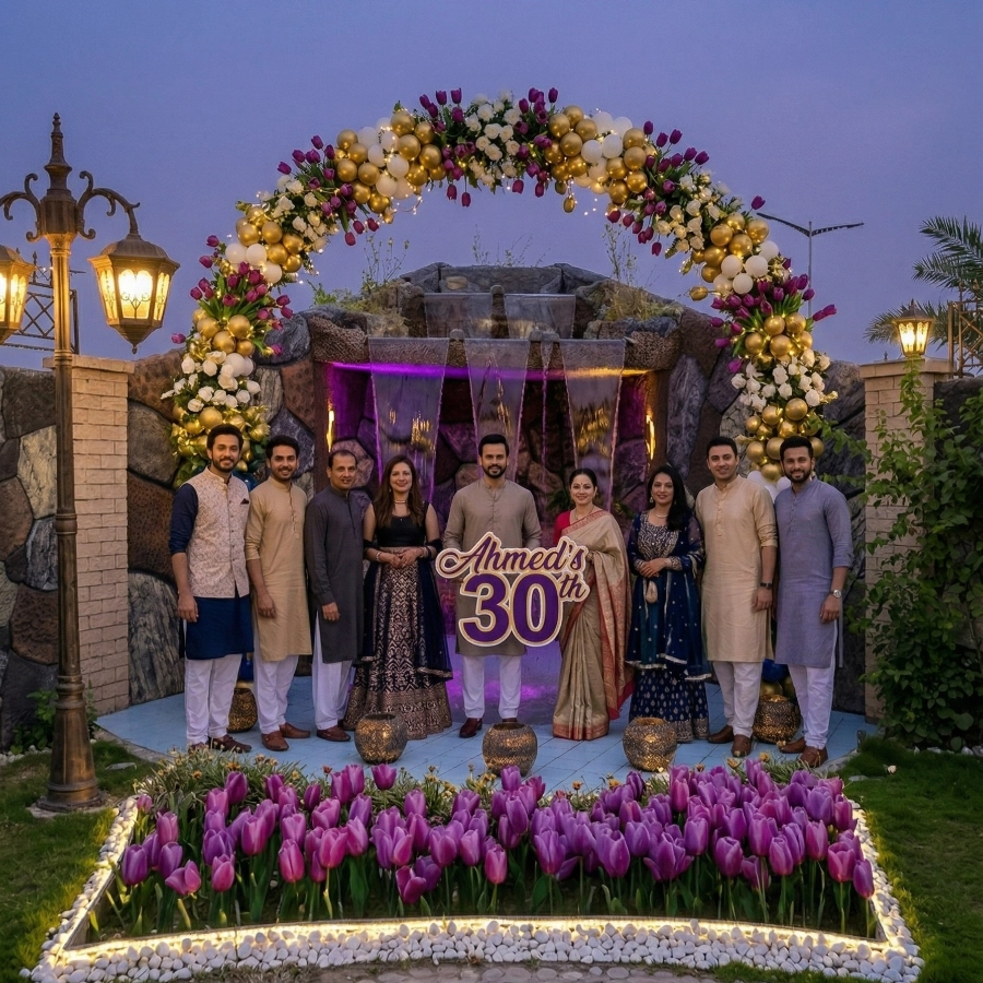 Guests celebrating Ahmed's 30th birthday at AH Royal Resort with a floral balloon arch, elegant décor, and scenic backdrop perfect for family events.