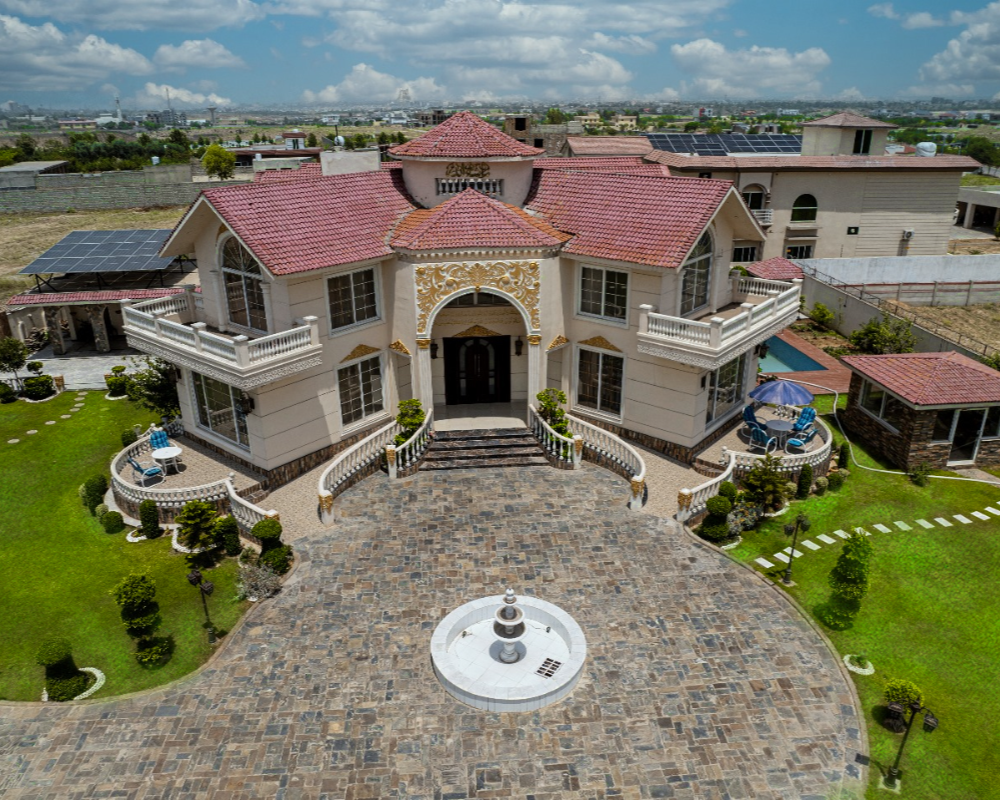 Luxury farmhouse aerial view with landscaped garden and fountain, ideal private photoshoot venue in Islamabad