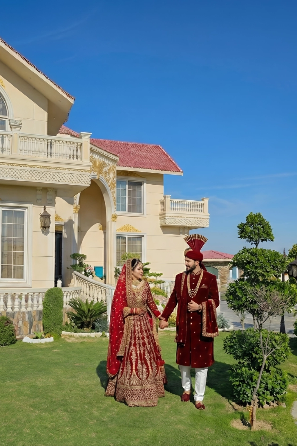 Newlywed couple in traditional attire walking at AH Royal Resort, a romantic honeymoon destination near Islamabad.