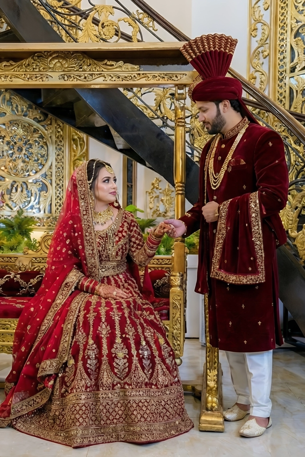 Bride and groom in elegant red wedding attire at AH Royal Resort, showcasing its romantic charm for a honeymoon near Islamabad.