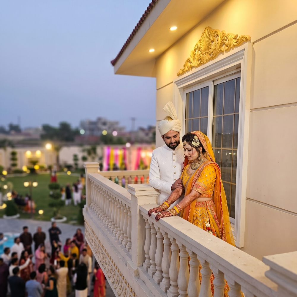 Bride and groom on a balcony during a Mehndi celebration, capturing romantic Mehndi photoshoot ideas for 2026