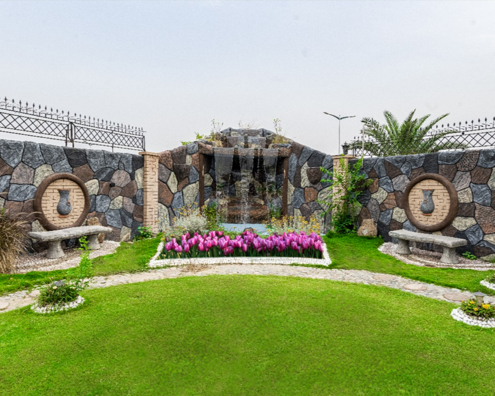 Scenic garden with waterfall and floral setup, private luxury photoshoot venue in Islamabad with elegant outdoor background
