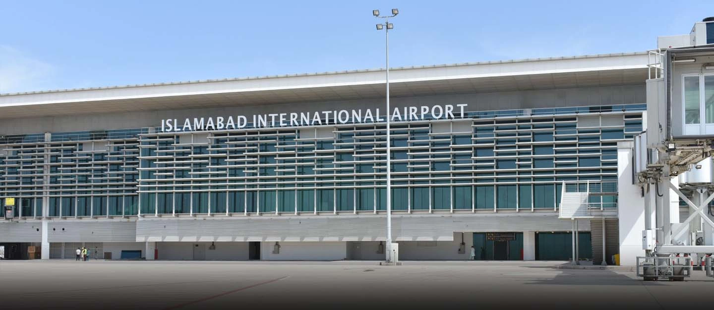 Front view of Islamabad International Airport showing modern architecture, glass façade, and arrival area for travelers visiting Islamabad in 2026.