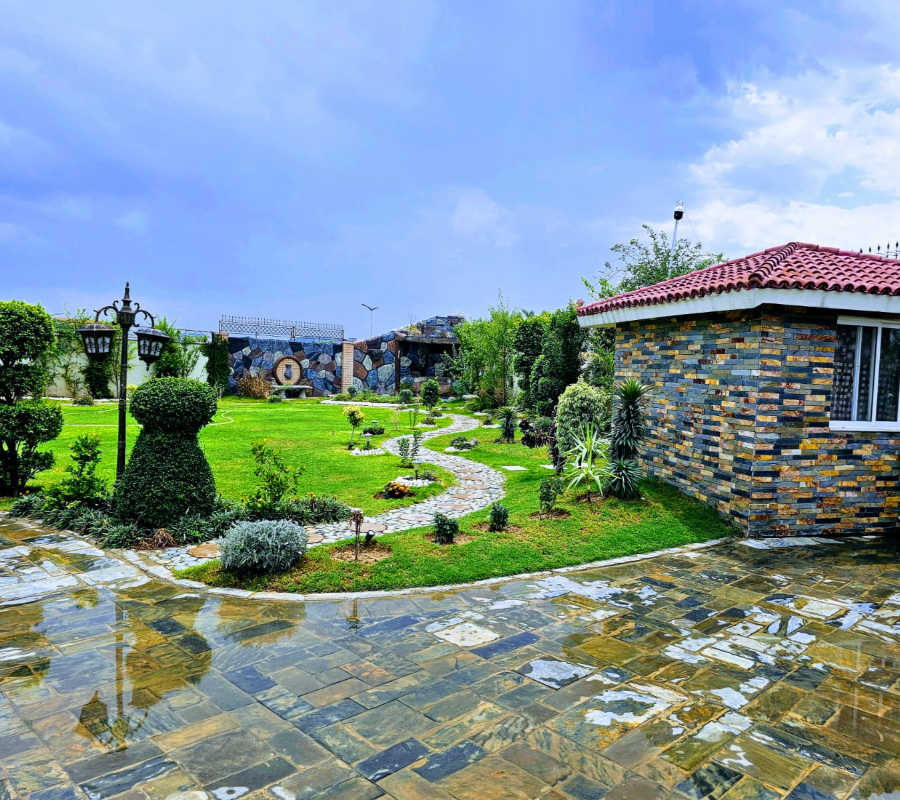 Luxury farmhouse garden near Islamabad with landscaped lawn, scenic pathways, and relaxing outdoor event atmosphere