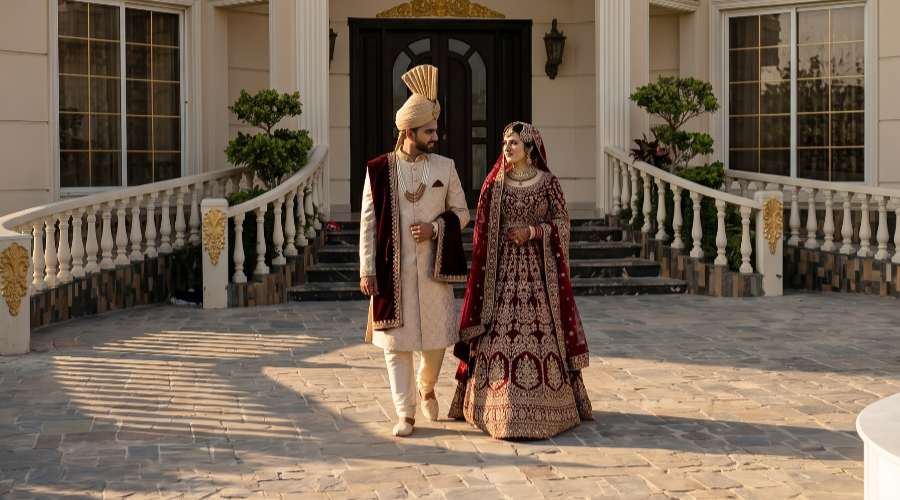 Bride and groom walking at AH Royal Resort Islamabad with grand architecture, capturing elegant bridal photoshoot setting