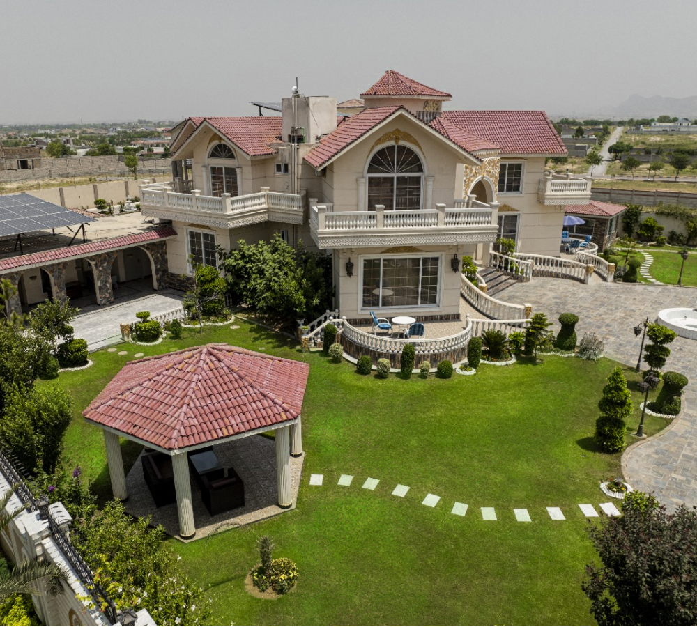 Luxury farmhouse nikkah venue near Islamabad with landscaped garden, gazebo seating, and elegant outdoor ceremony space