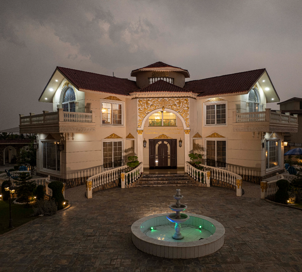 Private nikkah venue near Islamabad with grand illuminated entrance, courtyard fountain, and elegant luxury farmhouse setting