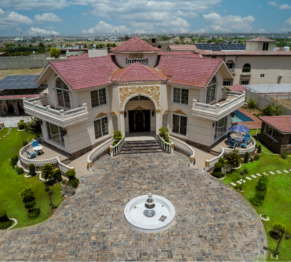 Luxury farmhouse nikkah venue near Islamabad with grand entrance, courtyard fountain, and elegant outdoor setting for weddings